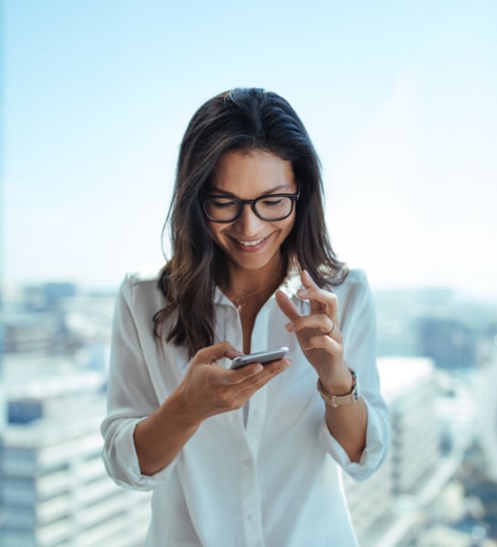 Business woman with smartphone in city